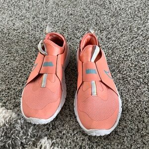 Girls orange Nike slide on sneakers